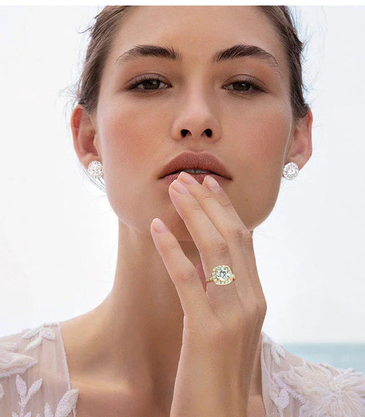 Woman wearing diamond ring and diamond stud earrings, close-up bridal jewelry photo