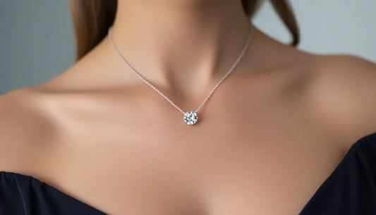 Close-up of woman wearing a round diamond pendant necklace on silver chain