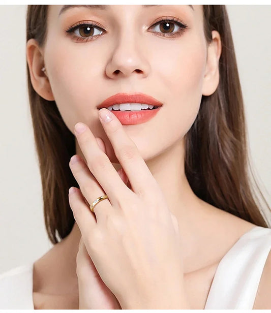 Woman wearing a gold ring with diamond accent, close-up jewelry fashion photo