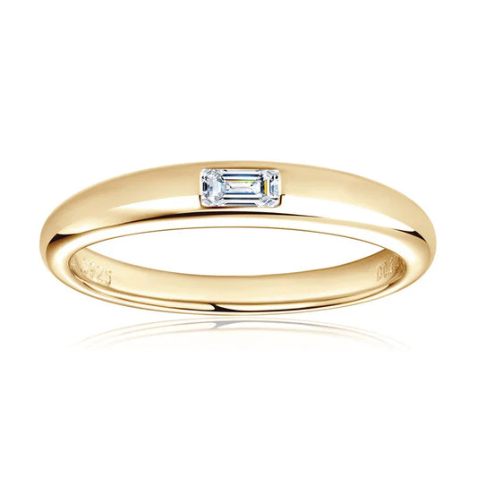 Gold ring with a rectangular emerald-cut diamond set at the center, minimalist jewelry