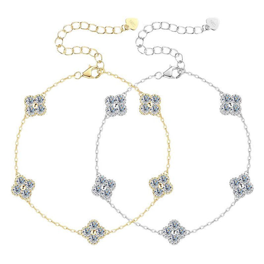 Gold and silver flower-shaped crystal bracelets with adjustable chains on white background