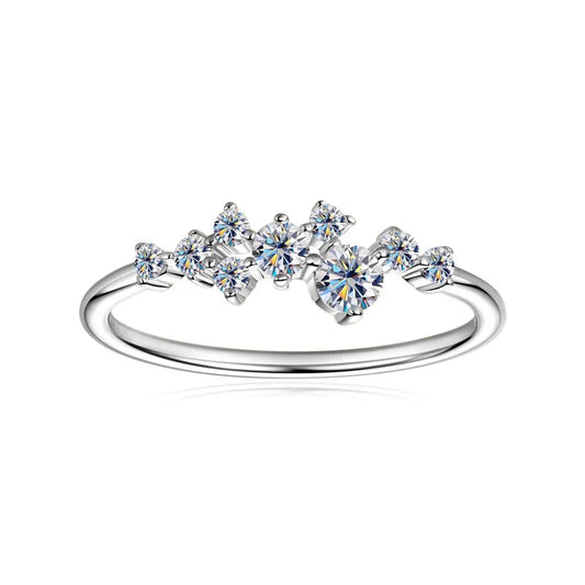 Delicate silver ring with clustered round-cut cubic zirconia stones on white background