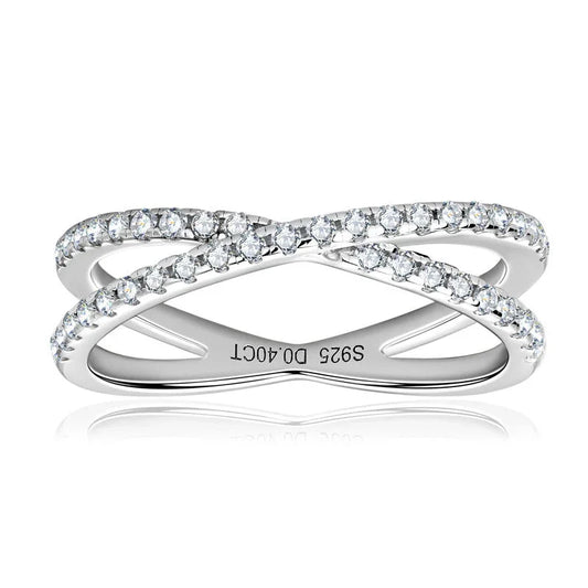 Sterling silver criss cross ring with sparkling cubic zirconia stones on a white background