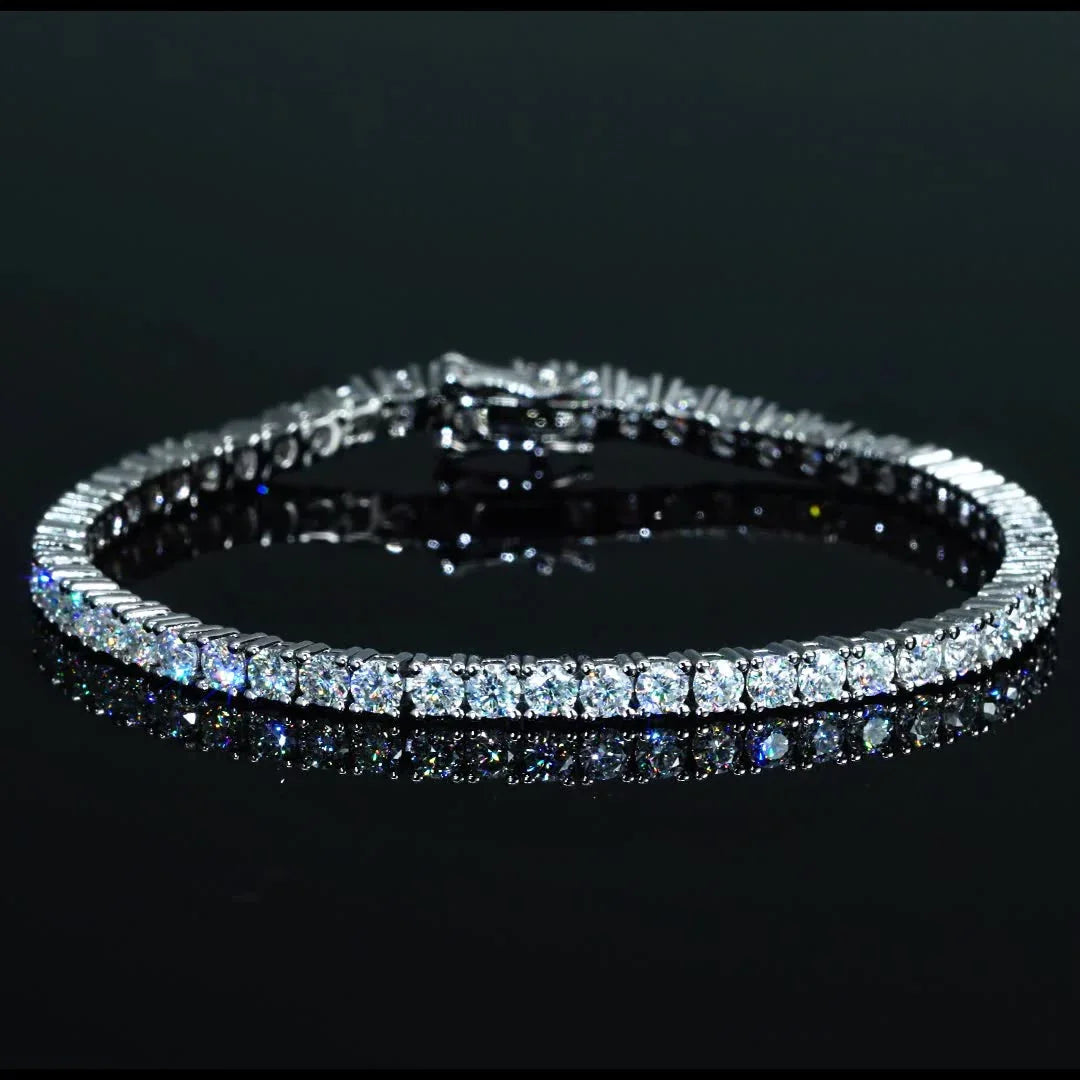 Diamond tennis bracelet with round cut stones on black reflective surface