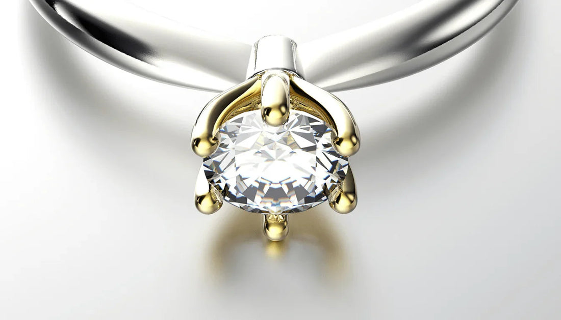 Close-up of a diamond engagement ring with a gold prong setting on a silver band