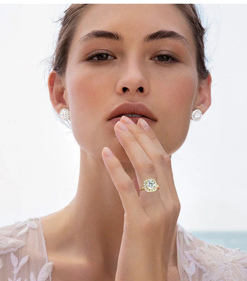 Woman wearing diamond ring and diamond stud earrings, close-up bridal jewelry photo