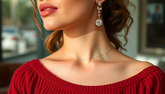 Woman in red sweater wearing elegant long diamond drop earrings and delicate necklace